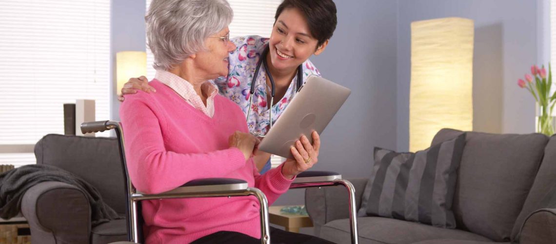Asian woman and Elderly patient talking with tablet