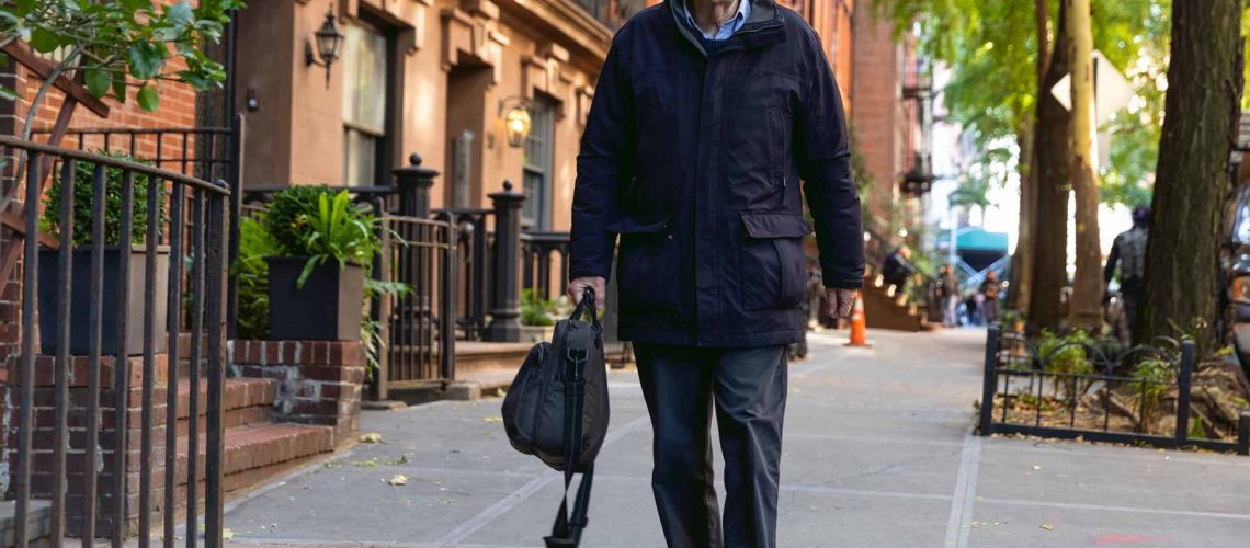 Senior caucasian man walking down the streets in New York city enjoying his free time.